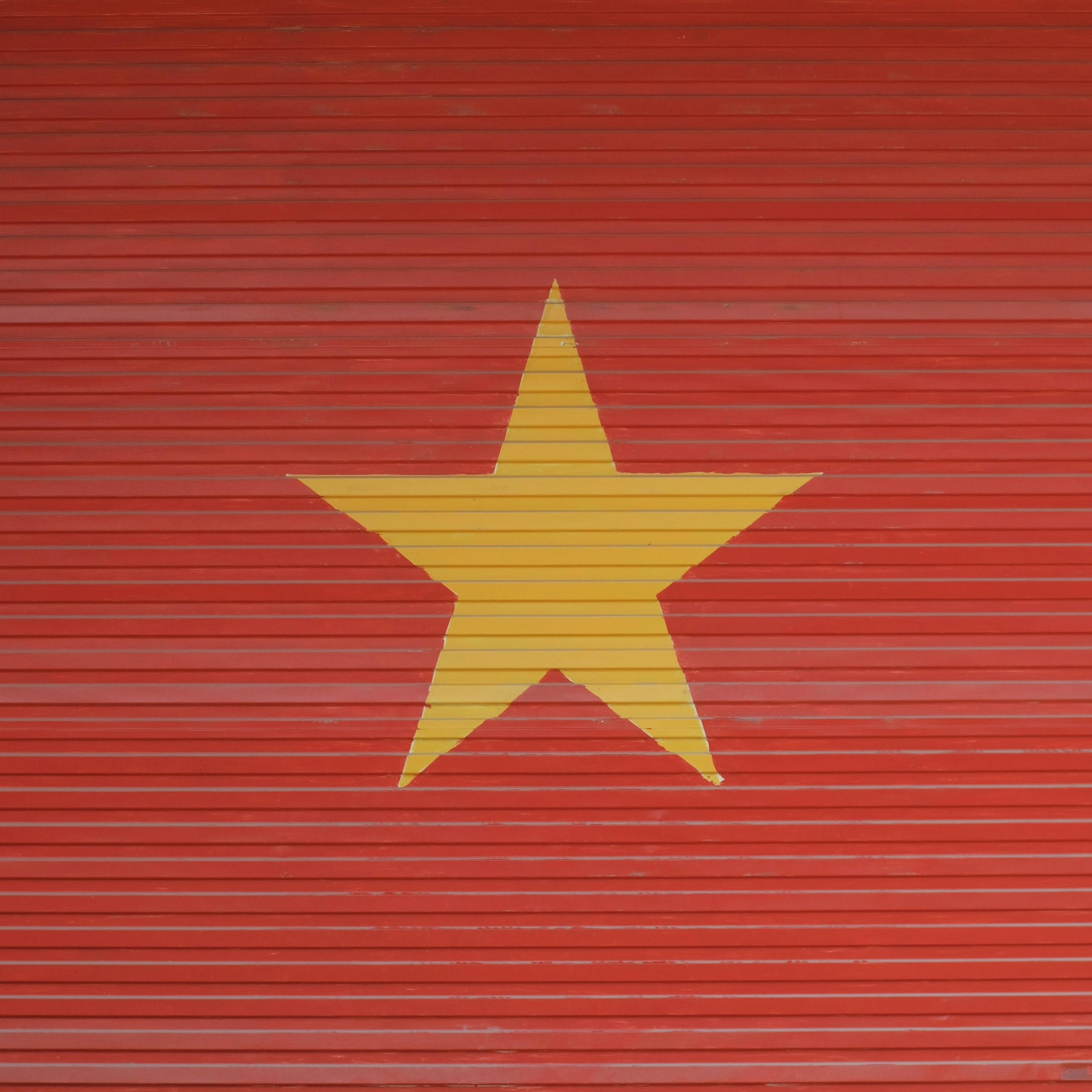 A red shutter featuring a large yellow star, symbolizing Vietnam.
